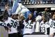 Seattle Seahawks players dance in front of the Vince Lombardi Trophy at a rally following a parade for the NFL football Super Bowl XLVIII champions on Wednesday, Feb. 5, 2014, in Seattle. The Seahawks defeated the Denver Broncos on Sunday. (AP Photo/Elaine Thompson)