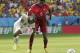 Ghana's Emmanuel Agyemang-Badu falls as he fights for the ball with Portugal's William Carvalho during the group G World Cup soccer match between Portugal and Ghana at the Estadio Nacional in Brasilia, Brazil, Thursday, June 26, 2014. (AP Photo/Marcio Jose Sanchez)