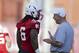 Nebraska head coach Bo Pelini, right, talks to safety Corey Cooper (6) during Nebraska's first day of NCAA college football practice in Lincoln, Neb., Monday, Aug. 4, 2014. (AP Photo/Nati Harnik)