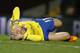 Arsenal's Nacho Monreal puts his hands to his head as he lies injured on the ground during the English Premier League soccer match between Aston Villa and Arsenal at Villa Park stadium in Birmingham, England, Monday, Jan. 13, 2014. (AP Photo/Kirsty Wigglesworth)