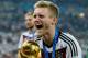 RIO DE JANEIRO, BRAZIL - JULY 13: Andre Schuerrle celebrates with the World Cup trophy after defeating Argentina 1-0 in extra time during the 2014 FIFA World Cup Brazil Final match between Germany and Argentina at Maracana on July 13, 2014 in Rio de Janeiro, Brazil. (Photo by Matthias Hangst/Getty Images)