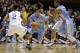 Duke's Quinn Cook (2) and Andre Dawkins (34) defend as North Carolina's Marcus Paige (5) drives while Leslie McDonald, right, blocks during the first half of an NCAA college basketball game in Durham, N.C., Saturday, March 8, 2014. (AP Photo/Gerry Broome)