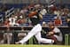 Cincinnati Reds catcher Devin Mesoraco and Miami Marlins batter Giancarlo Stanton watch as Stanton hits a double during the first inning of a baseball game in Miami, Saturday, Aug. 2, 2014. (AP Photo/J Pat Carter)