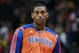 New York Knicks forward Metta World Peace warms up before facing the Denver Nuggets in the first quarter of an NBA basketball game in Denver on Friday, Nov. 29, 2013. (AP Photo/David Zalubowski)