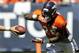 Denver Broncos running back Montee Ball takes a handoff before the start of the NFL Broncos Summer Scrimmage at Sports Authority Field at Mile High on Saturday, Aug. 2, 2014, in Denver. (AP Photo/Chris Schneider)