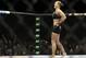 Ronda Rousey celebrates after defeating Alexis Davis in their women's mixed martial arts bantamweight title bout at UFC 175 Saturday, July 5, 2014, in Las Vegas. (AP Photo/John Locher)