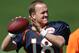 Denver Broncos quarterback Peyton Manning warms up during the morning session at the team's NFL training camp at Broncos headquarters in Englewood, Colo., on Friday, Aug. 1, 2014. (AP Photo/David Zalubowski)