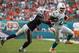 Miami Dolphins running back Lamar Miller (26) gets away from a tackle by New England Patriots cornerback Alfonzo Dennard (37) during the second half of an NFL football game, Sunday, Dec. 15, 2013, in Miami Gardens, Fla. (AP Photo/J Pat Carter)