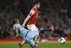 Arsenal's Olivier Giroud, back, vies for the ball with Manchester City's Fernandinho during the English Premier League soccer match between Arsenal and Manchester City at the Emirates stadium in London, Saturday, March 29, 2014. (AP Photo/Kirsty Wigglesworth)