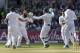 England's Moeen Ali, center left, celebrates with teammates after taking the wicket of India's Ajinkya Rahane for 1 on the third day of the fourth test match of their five match series at Old Trafford cricket ground, in Manchester, England, Saturday, Aug. 9, 2014. (AP Photo/Jon Super)