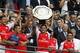 Arsenal's Mikel Arteta raises the trophy after their win against Manchester City at the end of their English Community Shield soccer match at Wembley Stadium in London, Sunday, Aug. 10, 2014. (AP Photo/Sang Tan)