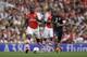 Making his debut Arsenal's Joel Campbell competes for the ball with Benfica's Maxi Pereira, right, during the Emirates Cup soccer match between between Arsenal and Benfica at Arsenal's Emirates Stadium in London, Saturday, Aug. 2, 2014. (AP Photo/Matt Dunham)