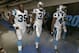 Carolina Panthers players , from left, Mike Tolbert, James Dockery, and Colin Jones, walk down the tunnel toward the field before a preseason NFL football game against the Buffalo Bills in Charlotte, N.C., Friday, Aug. 8, 2014. (AP Photo/Chuck Burton)