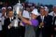 LOUISVILLE, KY - AUGUST 10: Rory McIlroy of Northern Ireland celebrates with the Wanamaker trophy after his one-stroke victory during the final round of the 96th PGA Championship at Valhalla Golf Club on August 10, 2014 in Louisville, Kentucky. (Photo by Andrew Redington/Getty Images)