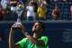 TORONTO, ON - AUGUST 10: Jo-Wilfried Tsonga of France holds up the Rogers Cup trophy after his win against Roger Federer of Switzerland during Rogers Cup at Rexall Centre at York University on August 10, 2014 in Toronto, Canada. (Photo by Ronald Martinez/Getty Images)