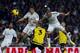 Real Madrid's Karim Benzema from France, right, scores his goal in between players during a Spanish La Liga soccer match between Real Madrid and Sevilla at the Santiago Bernabeu stadium in Madrid, Spain, Wednesday Oct. 30, 2013. (AP Photo/Andres Kudacki)