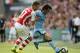 Arsenal's Calum Chambers, left, challenges Manchester City's David Silva during the English FA Community Shield soccer match at Wembley Stadium, London Sunday, Aug. 10, 2014. (AP Photo/Alastair Grant)