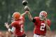 Cleveland Browns quarterbacks Johnny Manziel (2) and Brian Hoyer pass during practice at NFL football training camp in Berea, Ohio Tuesday, Aug. 12, 2014. (AP Photo/Mark Duncan)