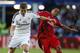 Real Madrid’s Toni Kroos fights for the ball with Sevilla’s Carlos Bacca, left, during the UEFA Super Cup soccer match between Real Madrid and Sevilla in Cardiff City Stadium, in Cardiff, Wales, Tuesday, Aug. 12, 2014. (AP Photo/Alastair Grant)