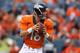 DENVER, CO - AUGUST 07: Quarterback Peyton Manning #18 of the Denver Broncos drops back to pass against the Seattle Seahawks during preseason action at Sports Authority Field at Mile High on August 7, 2014 in Denver, Colorado. (Photo by Doug Pensinger/Getty Images)