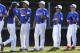 In this Aug. 6, 2014, photo, New Jersey's Kayla Roncin, of Toms River, N.J., is greeted by Delaware players during team introductions prior to their baseball game in the Little League Eastern Regionals at Breen Stadium in Bristol, Conn.Roncin and Pennsylvania's Mo’Ne Davis are competing to make it to the Little League World Series, a rare feat for girls. (AP Photo/Charles Krupa)