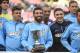 July 27, 2014; San Francisco, CA, USA; Atletico Madrid player Arda Turan (10) holds the winner's trophy with his team after the match against the San Jose Earthquakes at Candlestick Park. Atletico Madrid defeated the Earthquakes 4-3 in a shootout. Mandatory Credit: Kyle Terada-USA TODAY Sports