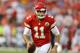 Kansas City Chiefs quarterback Alex Smith (11) scrambles in the first half of an NFL preseason football game against the Cincinnati Bengals Thursday, Aug. 7, 2014, in Kansas City, Mo. (AP Photo/Ed Zurga)