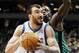 Minnesota Timberwolves center Nikola Pekovic (14) drives around Boston Celtics forward Brandon Bass for a basket during the first half of an NBA basketball game Monday, April 1, 2013, in Minneapolis. (AP Photo/Genevieve Ross)