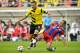Dortmund's Ciro Immobile, left, and Munich's Philipp Lahm vie for the ball with during the German soccer Super Cup match between Borussia Dortmund and Bayern Munich in Dortmund, Germany, Wednesday, Aug. 13, 2014. (AP Photo/Sascha Schuermann)