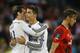 Real Madrid’s Gareth Bale, left and Cristiano Ronaldo hug as Sevilla’s Grzegorz Krychowiak walks off the pitch at the end of the UEFA Super Cup soccer match between Read Madrid and Sevilla at Cardiff City Stadium in Wales Tuesday, Aug. 12, 2014. Real Madrid won the match 2-0. (AP Photo/Kirsty Wigglesworth)