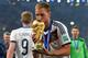 RIO DE JANEIRO, BRAZIL - JULY 13: Benedikt Hoewedes of Germany kisses the World Cup trophy after defeating Argentina 1-0 in extra time during the 2014 FIFA World Cup Brazil Final match between Germany and Argentina at Maracana on July 13, 2014 in Rio de Janeiro, Brazil. (Photo by Matthias Hangst/Getty Images)