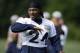 Seattle Seahawks running back Marshawn Lynch talks with a teammate during a session of NFL football training camp, Tuesday, Aug. 5, 2014, in Renton, Wash. (AP Photo/Ted S. Warren)