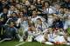 Real Madrid players pose with the trophy after winning the UEFA Super Cup soccer match between Real Madrid and Sevilla in Cardiff City Stadium, in Cardiff, Wales, Tuesday, Aug. 12, 2014. (AP Photo/Alastair Grant)