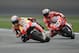 Marc Marquez, of Spain, leads Andrea Dovizioso, of Italy, through a turn during qualifying for the Indianapolis Moto GP motorcycle race at the Indianapolis Motor Speedway in Indianapolis, Saturday, Aug. 9, 2014. Marquez won the pole, Dovizioso was second. (AP Photo/Michael Conroy)