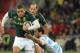 South Africa's Bryan Habana, left, is challenged by Argentina's Martin Landajo, right, as his teammate Fourie du Preez, back, looks on during their Rugby Test match at Soccer City Stadium in Johannesburg, South Africa, Saturday, Aug. 17, 2013. (AP Photo/Themba Hadebe)