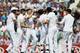 England's Chris Woakes, centre, celebrates with teammates after taking the wicket of India's Murali Vijay during the first day of the fifth test cricket match at Oval cricket ground in London, Friday, Aug. 15, 2014. (AP Photo/Alastair Grant)