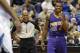 Phoenix Suns guard Eric Bledsoe (2) laughs after talking with referee Sean Corbin, left, during the third quarter of an NBA basketball game against the Minnesota Timberwolves in Minneapolis, Sunday, March 23, 2014. The Suns won 127-120. (AP Photo/Ann Heisenfelt)