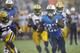 Tennessee Titans running back Shonn Greene (23) runs 13 yards for a touchdown as Green Bay Packers defenders Brad Jones (59), Mike Daniels (76) and Datone Jones (95) chase him in the first quarter of a preseason NFL football game Saturday, Aug. 9, 2014, in Nashville, Tenn. (AP Photo/Wade Payne)