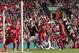 Southampton's Dejan Lovren, bottom right, scores against Liverpool during their English Premier League soccer match at Anfield Stadium, Liverpool, England, Saturday Sept. 21, 2013. (AP Photo/Jon Super)