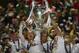 Real Madrid players lift the Champion League trophy after winning the Champions League final soccer match between Atletico Madrid and Real Madrid in Lisbon, Portugal, Saturday, May 24, 2014. (AP Photo/Manu Fernandez)
