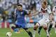 Argentina's Ezequiel Lavezzi, left, is challenged by Germany's Benedikt Hoewedes during the World Cup final soccer match between Germany and Argentina at the Maracana Stadium in Rio de Janeiro, Brazil, Sunday, July 13, 2014. (AP Photo/Victor R. Caivano)