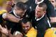Australia's Kurtley Beale, center, is wrapped up by the New Zealand defense during their Bledisloe Cup rugby union test match in Sydney, Saturday, Aug. 16, 2014. (AP Photo/Rick Rycroft)