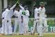 Pakistan's Khurram Manzoor leaves the pitch after being dismissed as Sri Lankan cricketers celebrate during the second day of the second test cricket match between Sri Lanka and Pakistan in Colombo, Sri Lanka, Friday, Aug. 15, 2014. (AP Photo/Eranga Jayawardena)