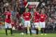 Manchester United players including captain Wayne Rooney, centre right, wait for play to resume after Swansea City's second goal during their English Premier League soccer match at Old Trafford Stadium, Manchester, England, Saturday, Aug. 16, 2014. (AP Photo/Jon Super)