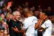 LONDON, ENGLAND - AUGUST 16: Kyle Naughton of Spurs reacts after receiving a red card for handball as Younes Kaboul of Spurs remenstrates with referee Chris Foy during the Barclays Premier League match between West Ham United and Tottenham Hotspur at Boleyn Ground on August 16, 2014 in London, England. (Photo by Julian Finney/Getty Images)