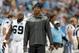 Carolina Panthers' Cam Newton walks the sidelines in street clothes as he rests his surgically repaired knee before a preseason NFL football game against the Buffalo Bills in Charlotte, N.C., Friday Aug. 8, 2014. The Bills won 20-18. (AP Photo/Bob Leverone)