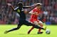 LIVERPOOL, ENGLAND - AUGUST 17: Joe Allen of Liverpool is tackled by Victor Wanyama of Southampton during the Barclays Premier League match between Liverpool and Southampton at Anfield on August 17, 2014 in Liverpool, England. (Photo by Alex Livesey/Getty Images)