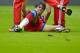 Munich's Javier Martinez lies injured on the pitch during the German soccer Super Cup match between Borussia Dortmund and Bayern Munich in Dortmund, Germany, Wednesday, Aug. 13, 2014. (AP Photo/Sascha Schuermann)
