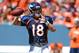 Aug 2, 2014; Denver, CO, USA; Denver Broncos quarterback Peyton Manning (18) prepares to throw as he warms up prior to the start of a scrimmage at Sports Authority Field. Mandatory Credit: Ron Chenoy-USA TODAY Sports