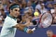 Roger Federer, from Switzerland, returns a volley to Milos Raonic, from Canada, during a semifinal at the Western & Southern Open tennis tournament, Saturday, Aug. 16, 2014, in Mason, Ohio. Federer won 6-2, 6-3. (AP Photo/David Kohl)